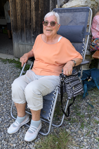 Trudi sitzt im Klappstuhl vor der Trotte